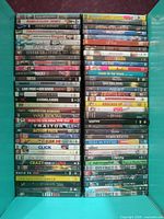 Full view of open box showing two columns of DVD cases with visible titles