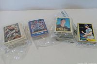 Four stacks of baseball cards in plastic bags