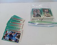 Stack of 1992 Donruss baseball cards in zip bag beside group of larger 1989 Topps Big cards fanned out