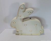 Front view of white bunny marquee light showing nine bulbs