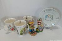 Front view showing three mugs, plate, two figurines