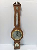 Full view of wood banjo weather station showing all gauges