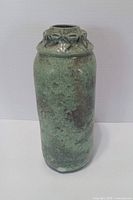Full upright view of green raku pottery vase