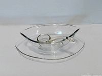 gravy boat on underplate with ladle resting inside