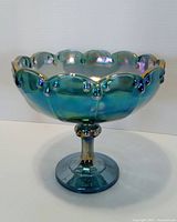 Side view of blue iridescent Indiana Glass Garland compote showing pedestal and garland motif