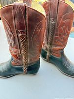 Both boots side view showing two-tone leather, shaft stitching, pull straps