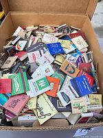 Open box filled with assorted vintage matchbooks
