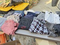 All pants spread on table showing variety and condition