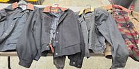 Four jackets laid out side by side on table