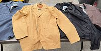 Four jackets laid out side by side showing overall styles and colors