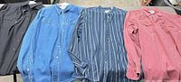 All four shirts laid flat side by side