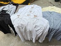 Assortment of 10 western pearl-snap shirts in various colors laid on table