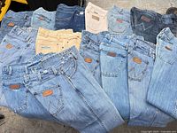 Top view showing all twelve jeans in various washes