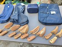 Overall lot showing Lucchese bags, cedar shoe trees on table