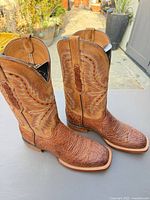 Side view of both boots showing shaft stitching and textured vamp