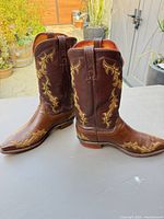 Side view of both boots showing embroidery and two-tone leather