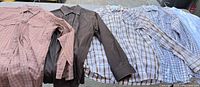 Five men’s western shirts laid out side by side