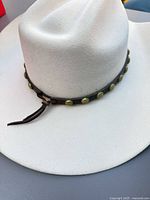 Profile of off-white gambler hat showing felt texture and studded leather band