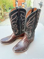 Side view of both boots showing square toe, croc-embossed vamp, stitched shaft