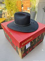 Wide shot of black Stetson hat on branded box showing overall hat shape and brim
