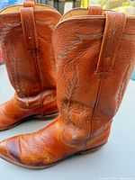 Side view of both boots showing color, stitching, toe shape and wear