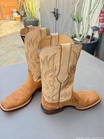 Side view showing suede vamp, stitched leather shaft, overall color and design