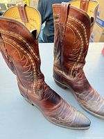 Full view of both boots showcasing color, stitching and overall condition