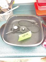 Skillet with lid and probe cord visible