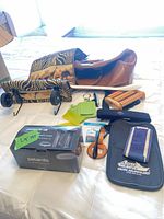 Overview of all items on bed including duffel bag, luggage cart, steamer box, accessories