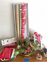 Multiple items including wrapping paper, centerpiece, lantern, glass jar, table linens, wooden signs