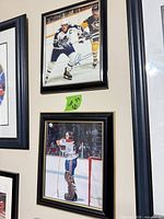 Both framed hockey images on wall to show size and frames
