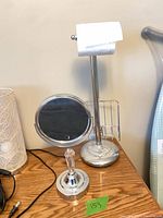 Vanity mirror and toilet paper holder on tabletop