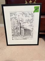 Full view of framed drawing showing church illustration, black frame, white mat