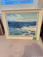 Front view of framed seascape painting showing entire artwork and frame