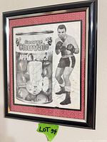 Framed signed George Chuvalo promotional poster on wall