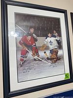 front view of framed hockey photo showing players and signatures