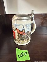 Stein right side view with lid closed showing buildings and shield