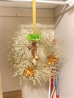 Full view of gold glitter twig wreath hanging, showing overall shape and size