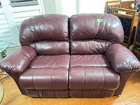 Front view of burgundy leather loveseat