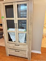 Front view of china cabinet showing glass doors and drawers