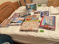 All ten puzzle boxes arranged on bed showing variety and overall condition