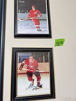 Both framed signed hockey photos hung on wall