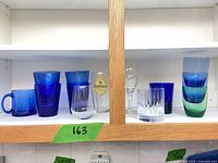 Full set of assorted glasses on shelf