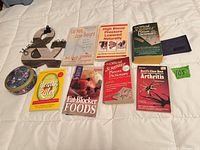 Overview of all books and accessories laid out on white quilt
