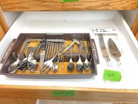 Drawer view showing entire lot with tray and packaged cake serving set