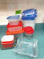 Entire grouping of plastic containers, lids, glass containers and serving bowl