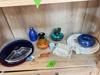 Full shelf view displaying all ceramic, glass and porcelain pieces
