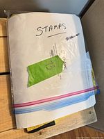 Closed resealable bag with paper packet labeled "STAMPS"