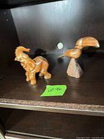 Front view of both wooden figurines on shelf