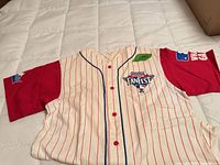 Front view showing button-front, pinstripes, red sleeves, chest crest, sleeve patch